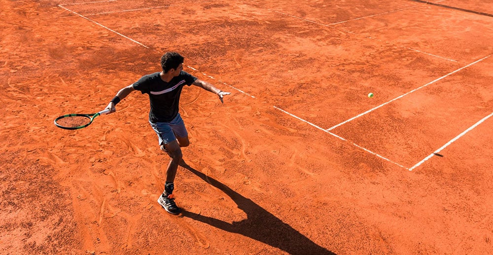 Tennis Player on red clay court at Mouratoglou Tennis Centre, Costa Navarino