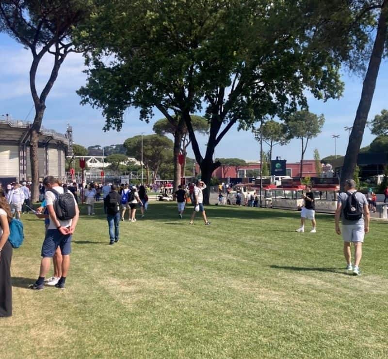 Visitors walking through the grounds at a tennis tournament in Rome